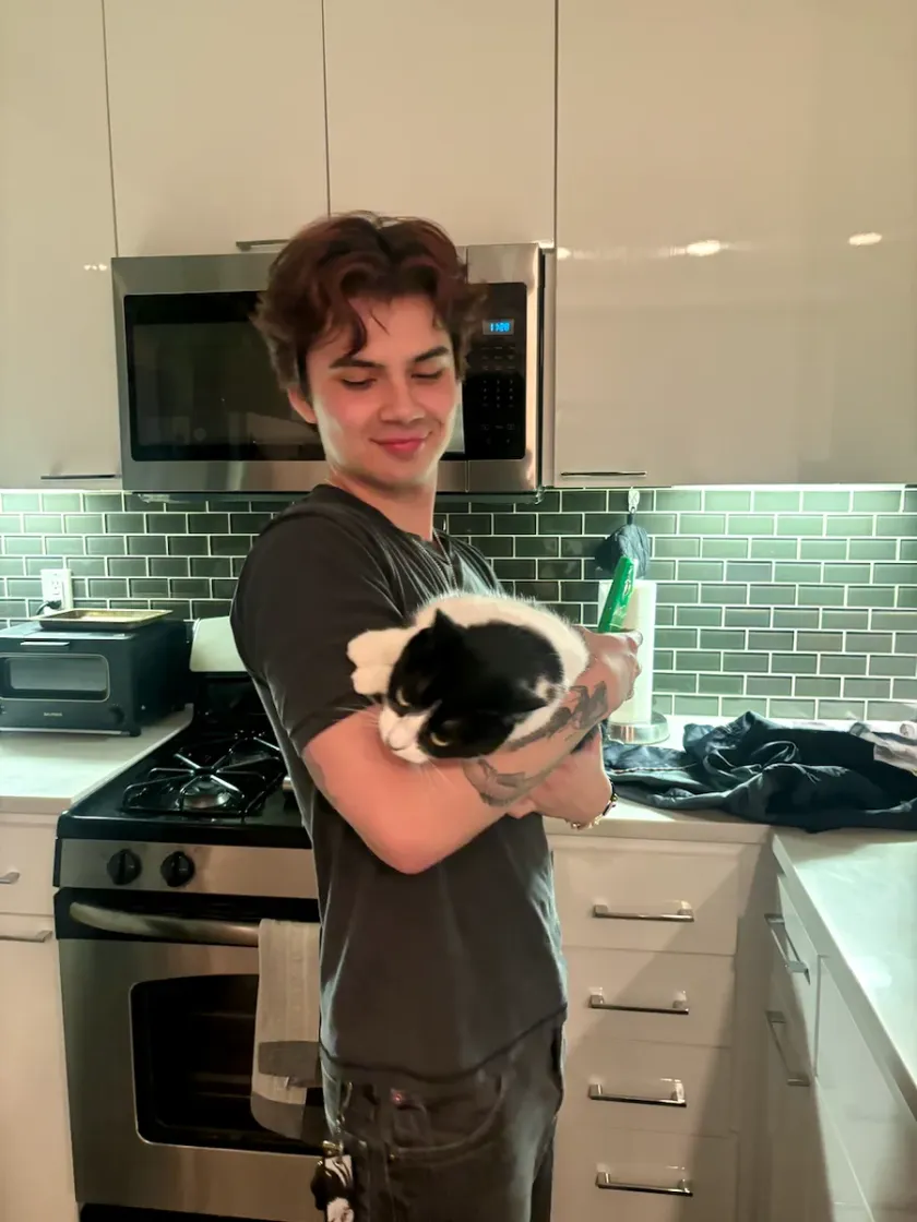 Gabriel Murray with Toast, his tuxedo cat